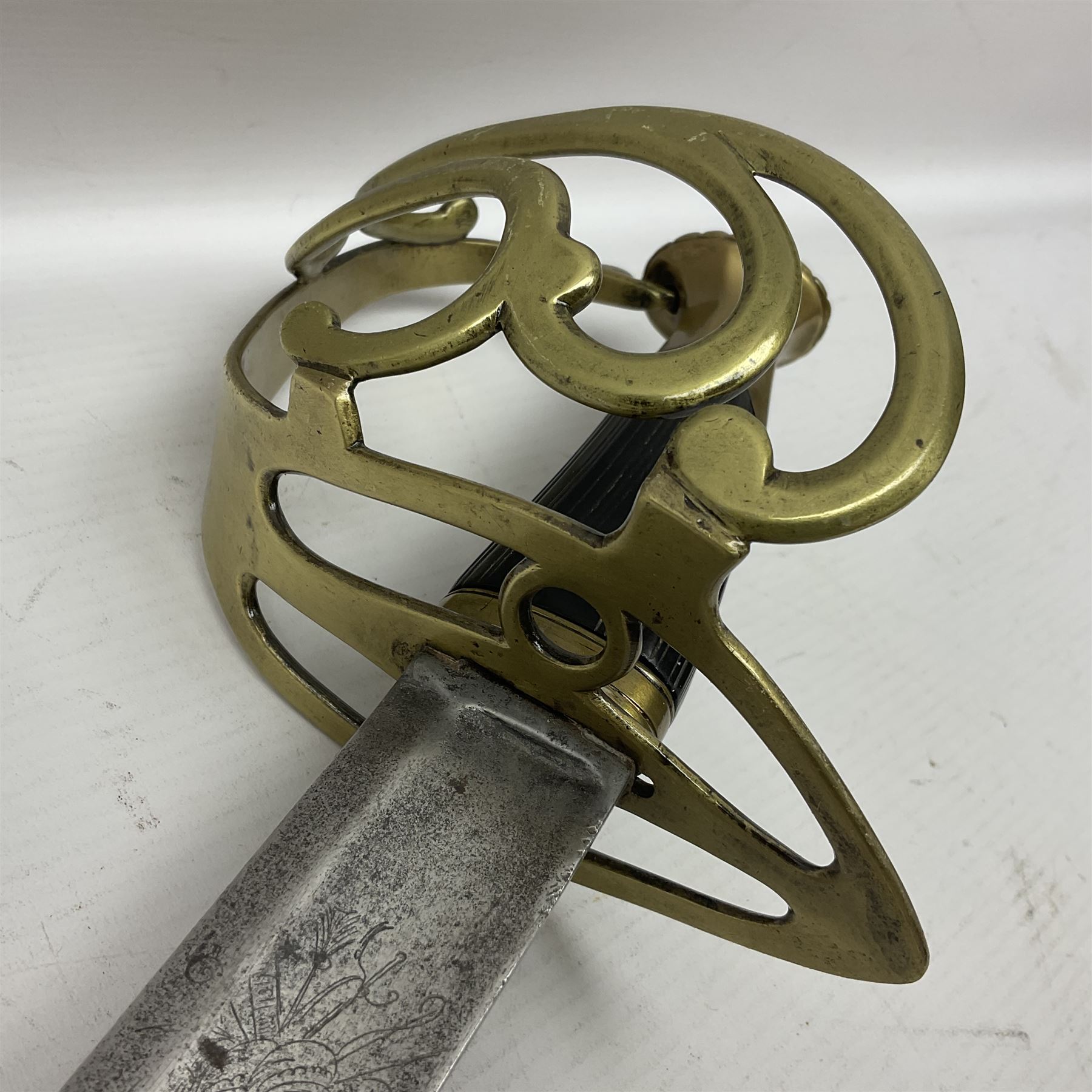 Late 18th century sword, the Spanish 79.5cm curving fullered blade engraved with the Royal Cypher, battle trophies and 'Viva Espania' banner, French Sabre de Mineur brass three-bar hilt with ebonised reeded grip L93.5cm overall (no scabbard)