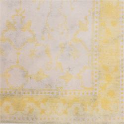 Tibetan wool rug, decorated with a pale cream ground and yellow all-over foliate design, enclosed by a broad yellow floral border and narrow inner guard band