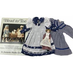 Heidi Ott doll in tartan dress, navy floral dress with white lace and ribbon detailing, striped blue and white dress and a 'Head to Toe' book