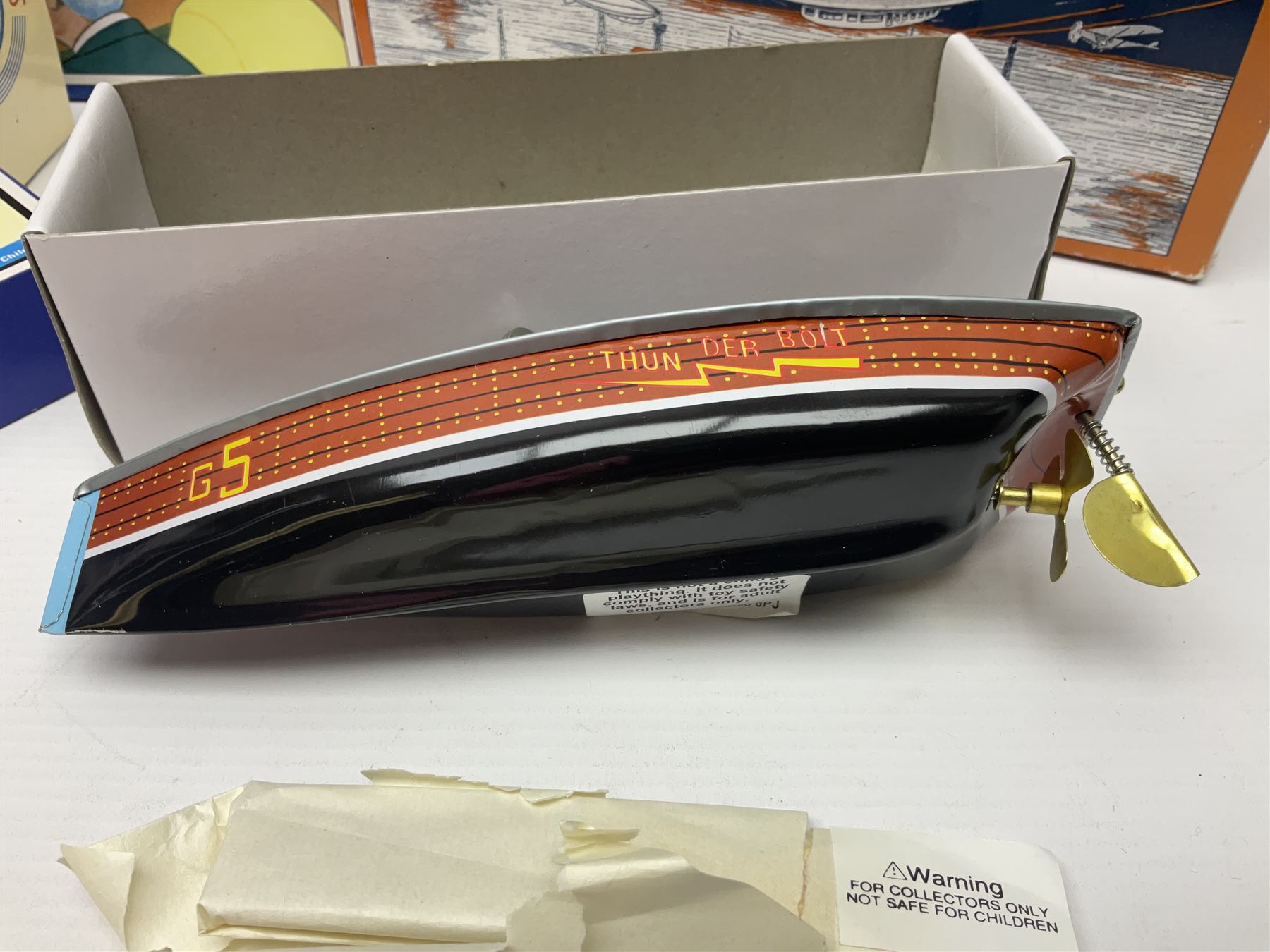 Schylling - six tinplate models comprising Sir Ian’s Bluebird racing car, Speedway Auto Racer, two Aluminium Airships, Tin Speedboat and Ernest in the Music Box; all in original boxes 