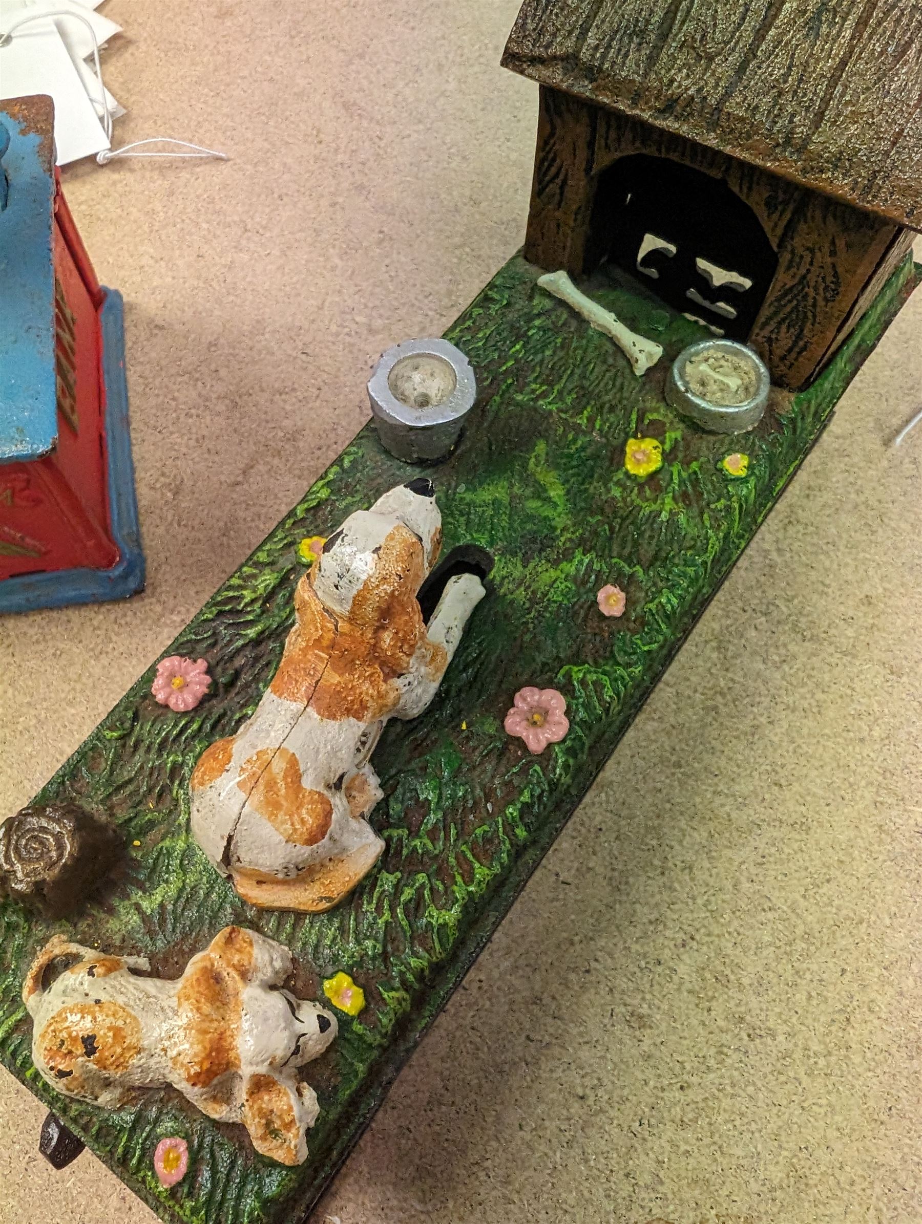 Two Reproduction cast metal money banks, one modelled as 'Uncle Sam', the other as a dog and kennel, tallest H27cm