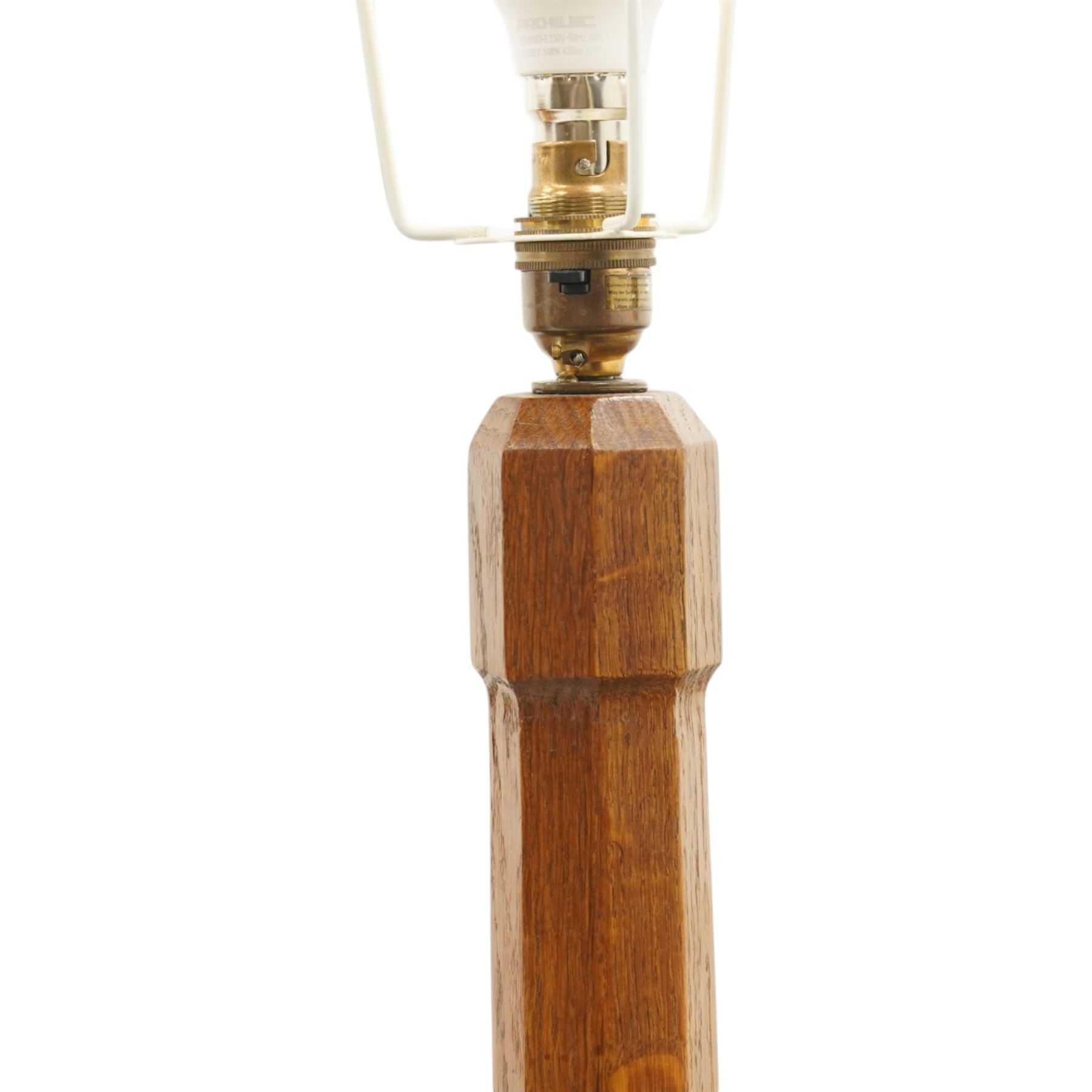 Mouseman - oak standard lamp, the turned octagonal column terminating to a stepped cavetto octagonal base, with carved mouse signature, by the workshop of Robert Thompson of Kilburn
