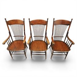 Set of three 19th century ash and elm spindle back Windsor armchairs, arched top rails above fan-shaped spindle backs, curved arms with turned supports, shaped saddle seats, on turned legs joined by H-stretchers