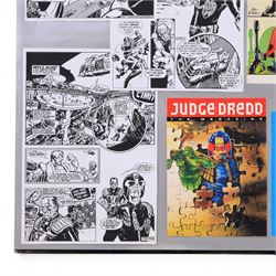 The X Files montage, including cast images, stills and advertisements, within acrylic frame, together with a Judge Dredd montage, including comic cover and comic strips, largest 46x61cm

Notes: This item is from the private collection of Arthur C. Clarke's brother.