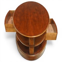 Willis & Gambier - oval coffee table, the moulded oval top above two central frieze drawers with handles either side, flanked by open shelves, raised on a shaped plinth base