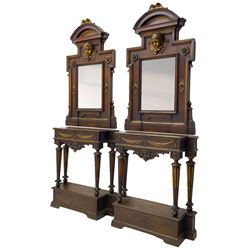Pair of 19th century Italian walnut and parcel gilt console tables with raised mirrors - arched pediment surmounted by scrolled carving, central projecting winged putto mask over plain rectangular mirror plate, in a rectangular moulded frame with extending upper corners, decorated with flower head and foliate mounts, the table of break-front rectangular form with moulded top, the frieze decorated with linen swags and bellflowers, foliate scroll carved apron, on four tapering and stop-fluted supports carved with flower heads, break-front moulded lower platform on bracket feet 