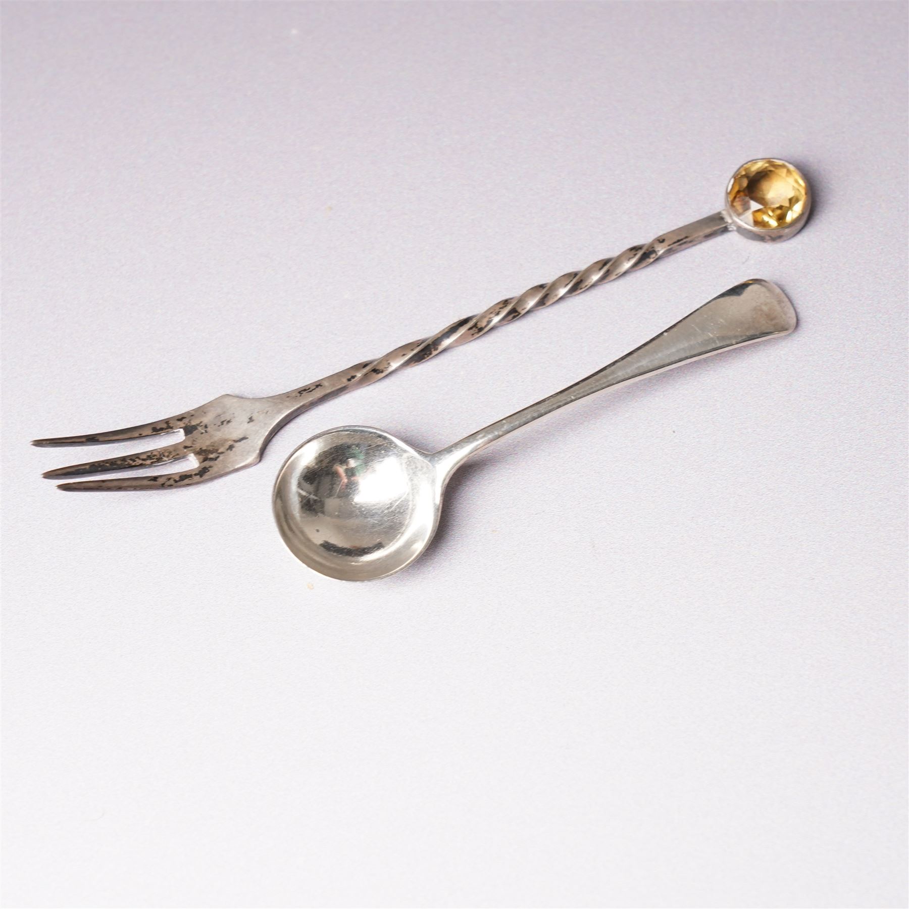 Small glass scent bottle with silver and red enamel cover, Edwardian silver cased scent flask with engraved decoration, heptagonal silver napkin ring, pair of small silver barrel shape salts, glass pepperette with silver and mother of pearl cover, small silver stone set fork by William Robb and a silver salt spoon