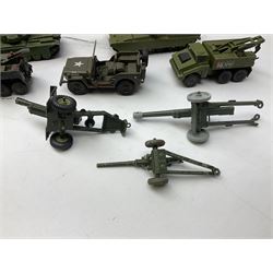 Twenty unboxed and playworn die-cast military vehicles predominantly by Dinky including tank transporters, tanks, lorries, field guns, jeeps, ambulances etc