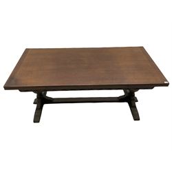 20th century oak drawer leaf extending dining table, two foliage carved baluster supports on sledge feet joined by floor stretcher 