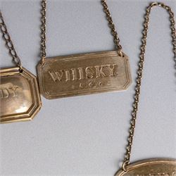 Five silver decanter labels, of varying design, including Bacardi, Vodka, Rum, Brandy and Whisky, all hallmarked together with two silver plated Gin and Sherry examples