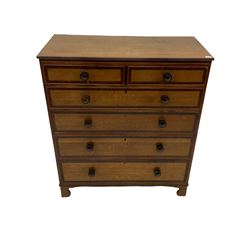 Early 19th century oak and mahogany banded chest, two short and four long graduating drawers with turned rosewood handles