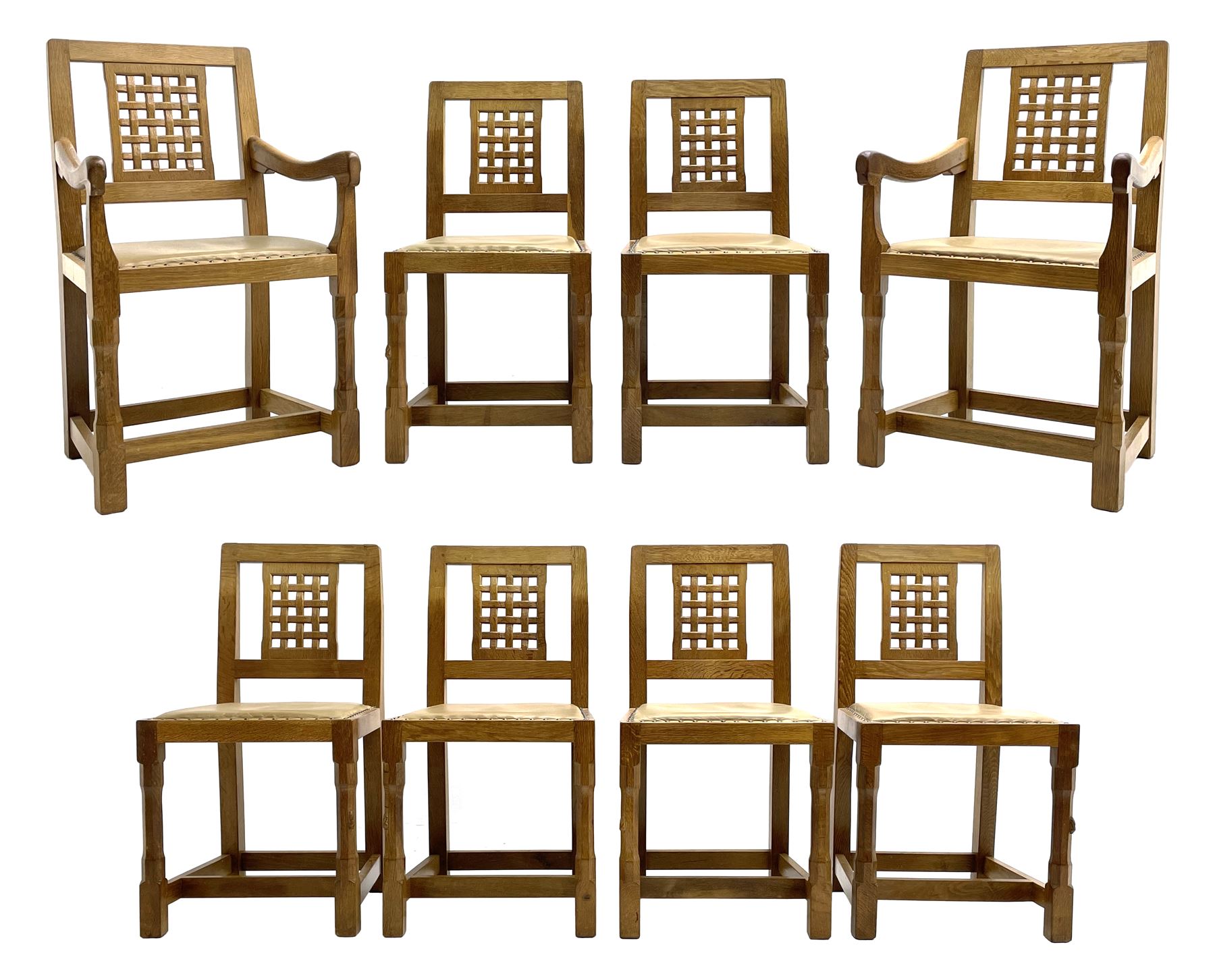 'Rabbitman' set of eight oak dining chairs, pierced lattice backs, upholstered seats with studwork band, octagonal front supports joined by stretchers, carved with rabbit signature, two carvers and six side chairs, by Peter Heap of Wetwang