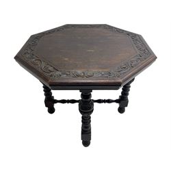 Late Victorian carved oak centre table, octagonal moulded top with carved scrolling foliage band, on five turned and foliate carved pillar supports joined by turned x-framed stretchers, on turned feet