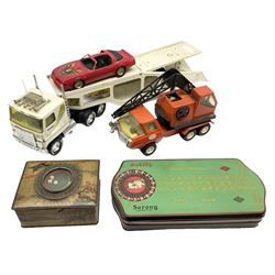 American Nylint large scale tin-plate car transporter L59cm carrying a Testor Toys plastic car; Tonka tin-plate mobile crane; boxed Sarony Cigarettes tin-plate roulette game with rules; and Japanese style tin-plate box, the lid inset with a revolving poker dice game (4)