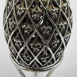 Modern silver limited edition Easter egg, no. 70/500, the openwork lattice body decorated with gilded panels of flower heads, opening to reveal a gilt interior, upon silver stand with three scrolling pad feet, each hallmarked St James House Company, London 1979, height including stand 8cm