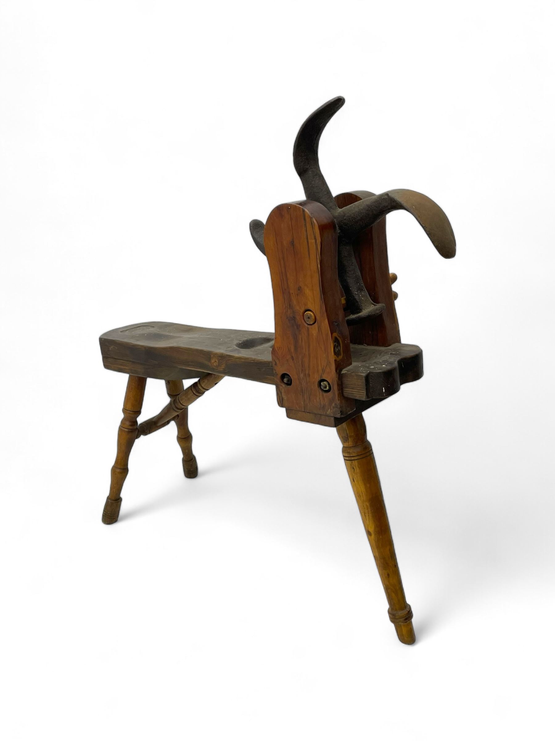 Early 19th century cobbler's work bench, in various woods, revolving cast iron last on yew wood supports, pine seat with inset maker's plaque inscribed 'No 7 Josh Blacker Harehills Leeds', on turned elm front supports and turned beech rear supports 