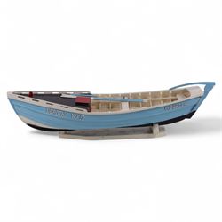Wooden model of the Whitby fishing coble WY.17 G.Burdon 'Dorothy', painted in blue and white with red detail, with rudder and oars, on a painted wooden stand, L73cm, H20cm