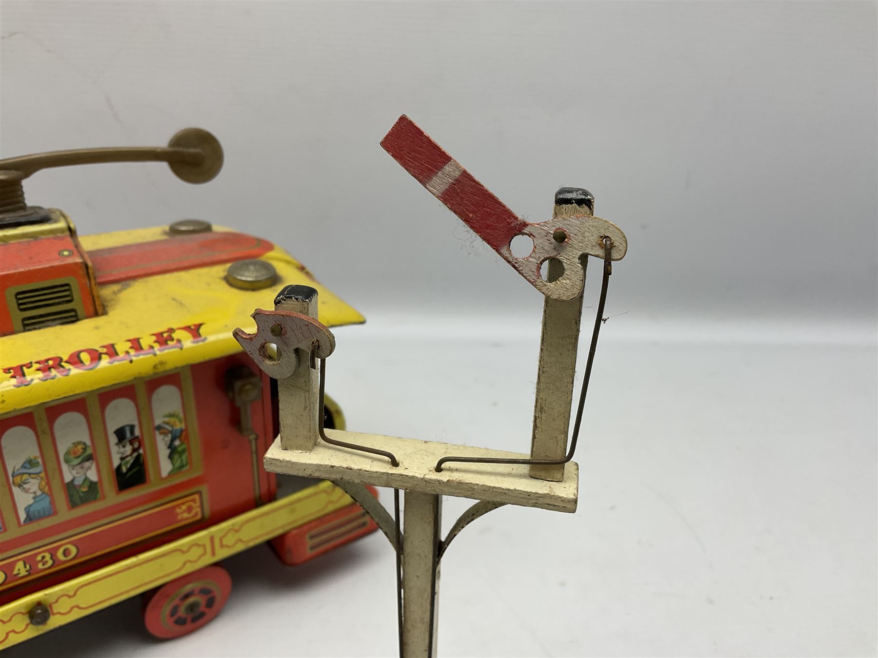 Chad Valley '0' gauge - clockwork tin-plate train set comprising LMS 0-4-0 tender locomotive No.3402 with two open wagons, loop of track and wooden signal; unboxed; and Japanese battery operated tin-plate Broadway Trolley bus No.10430