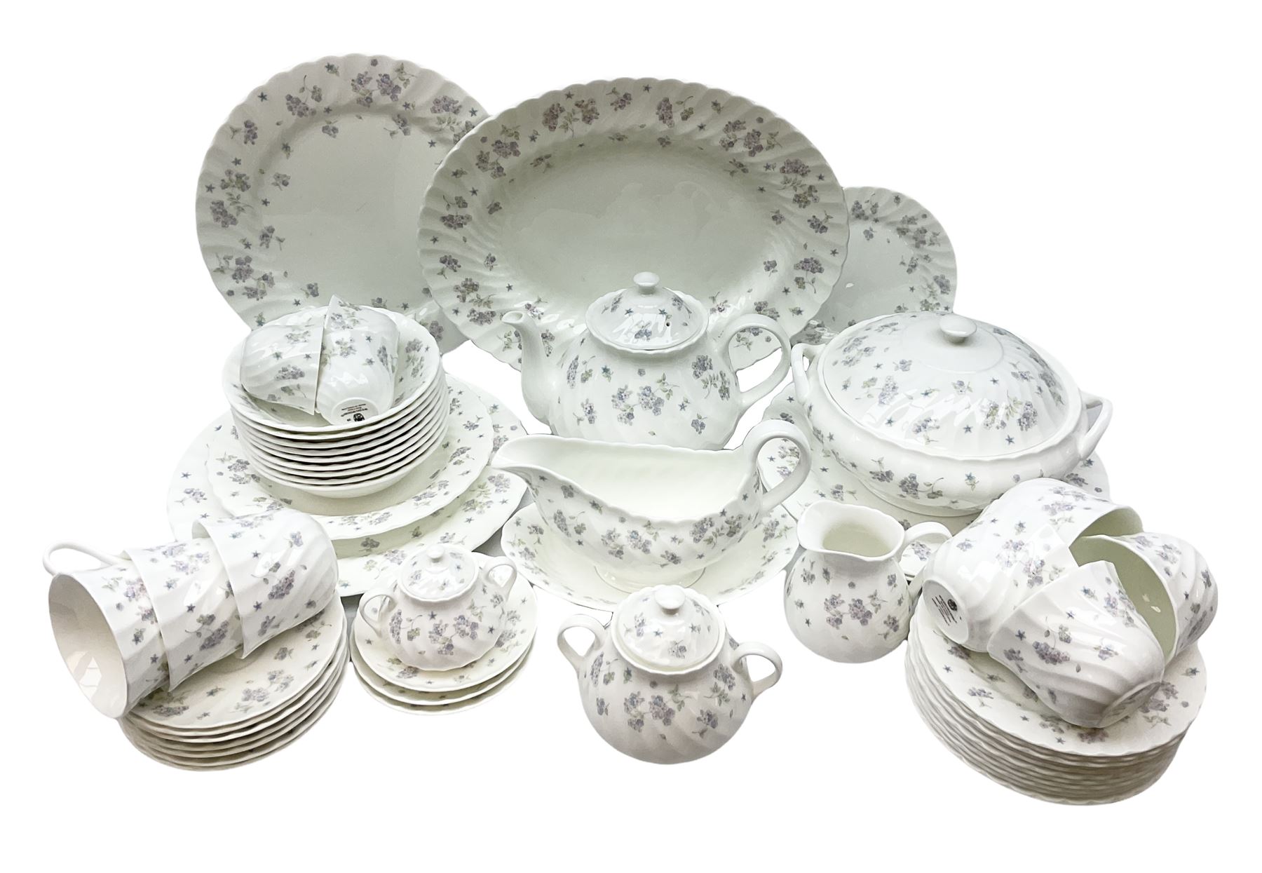 Wedgwood tea and dinner service decorated in the ‘April Flowers’ pattern, to include nine bowls, seven teacups and saucers, three coffee cups and saucers, sauce boat and stand, lidded tureen, covered sucrier and another smaller, oval serving plate, twelve side plates, teapot, four dinner plates, jug and shallow bowl
