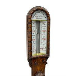 Negretti & Zambra of London - c1860 Victorian carved oak cistern tube storm barometer, with arch top glazed front ceramic scale inscribed “NEGRETTI & ZAMBRA OPTICIANS TO HER MAJESTY…LONDON” to panel above, double vernier canted scales inscribed with barometric air pressure in inches and weather predictions, rectangular trunk with vernier setting discs above a boxed Fahrenheit and Centigrade scale spirit thermometer, the base with carved cistern cover.  