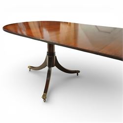 Arthur Brett & Sons - Regency design mahogany extending dining table and eight chairs, the oval top with rounded ends and two extension leaves, raised on twin pedestal supports with swept legs terminating in brass caps and castors, accompanied by a set of eight chairs comprising six single chairs and a pair of carvers, the chairs with curved backs and horizontal splat rails, upholstered seats, sabre legs and scrolling arms to the carvers
(Extends to 252cm)
(Chairs H 86cm, W 52cm)