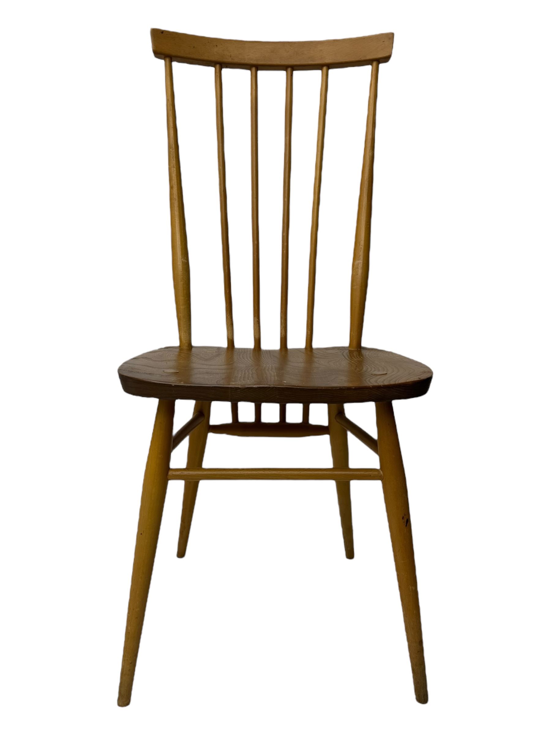Ercol - pair of mid-20th century highback 'Windsor' chairs, curved top rail over six vertical spindles and shaped seat, on tapering cylindrical supports with stretchers