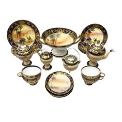 Noritake tea service for four, decorated with desert camel scene with blue border and gilding, comprising four teacups and saucers, four side plates, lidded sucrier, teapot and jug, together with twin handled pedestal bowl etc (19 pcs) 