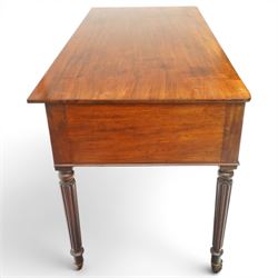 In the manner of Gillows - Regency period mahogany kneehole writing table, rectangular top over central cock-beaded frieze drawer with shaped spandrels, flanked by two graduating drawers to either side, raised on turned and fluted supports terminating to brass cups and castors