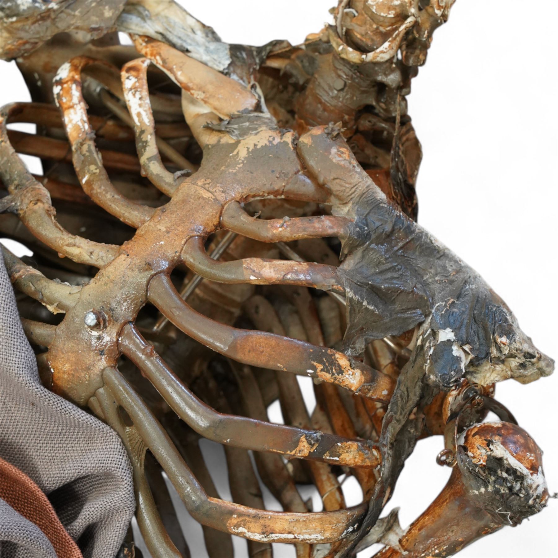 FILM PROPS; Three decomposing prop cadavers, collection of three life-size decomposing cadaver or dead body props, featuring skeletal elements, exposed flesh, and period clothing, each with articulated joints and limbs, likely from a TV or film production, each prop displays intricate detailing with realistic aging and weathering, together with post mortem cards detailing circumstances of death and identity, with two associated body bags max 160cm (3) 
Notes: the post-mortem cards correlate to a plane crash in 1972 - the Uruguay Air Force Flight 571 in the Andes Mountains; two movies were made about this event. Allegedly, the survivors resorted to cannibalism. 