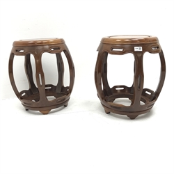 Pair Chinese rosewood circular barrel shaped occasional tables, five shaped supports joined by stretchers, D42cm, H46cm