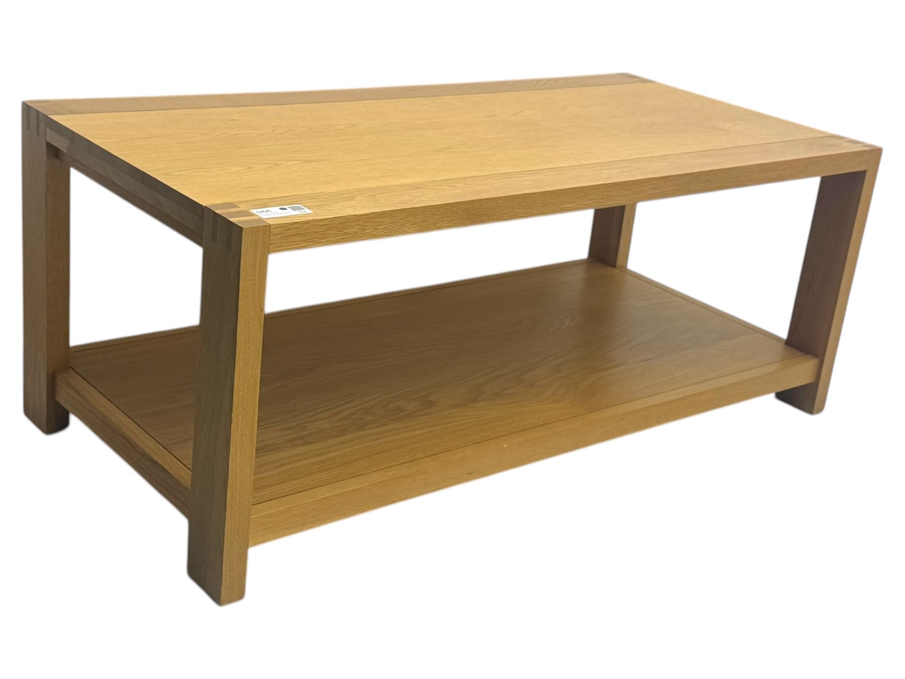 Light oak rectangular coffee table, with exposed finger joints to the corners, raised above a full-length undertier on straight supports