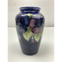 Moorcroft vase, decorated in Pansy pattern upon a dark blue ground, with impressed and painted marks beneath, H16cm