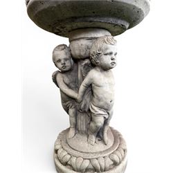 Cast stone cherub bird bath, circular removable top raised on three cherubs with ornate detailing