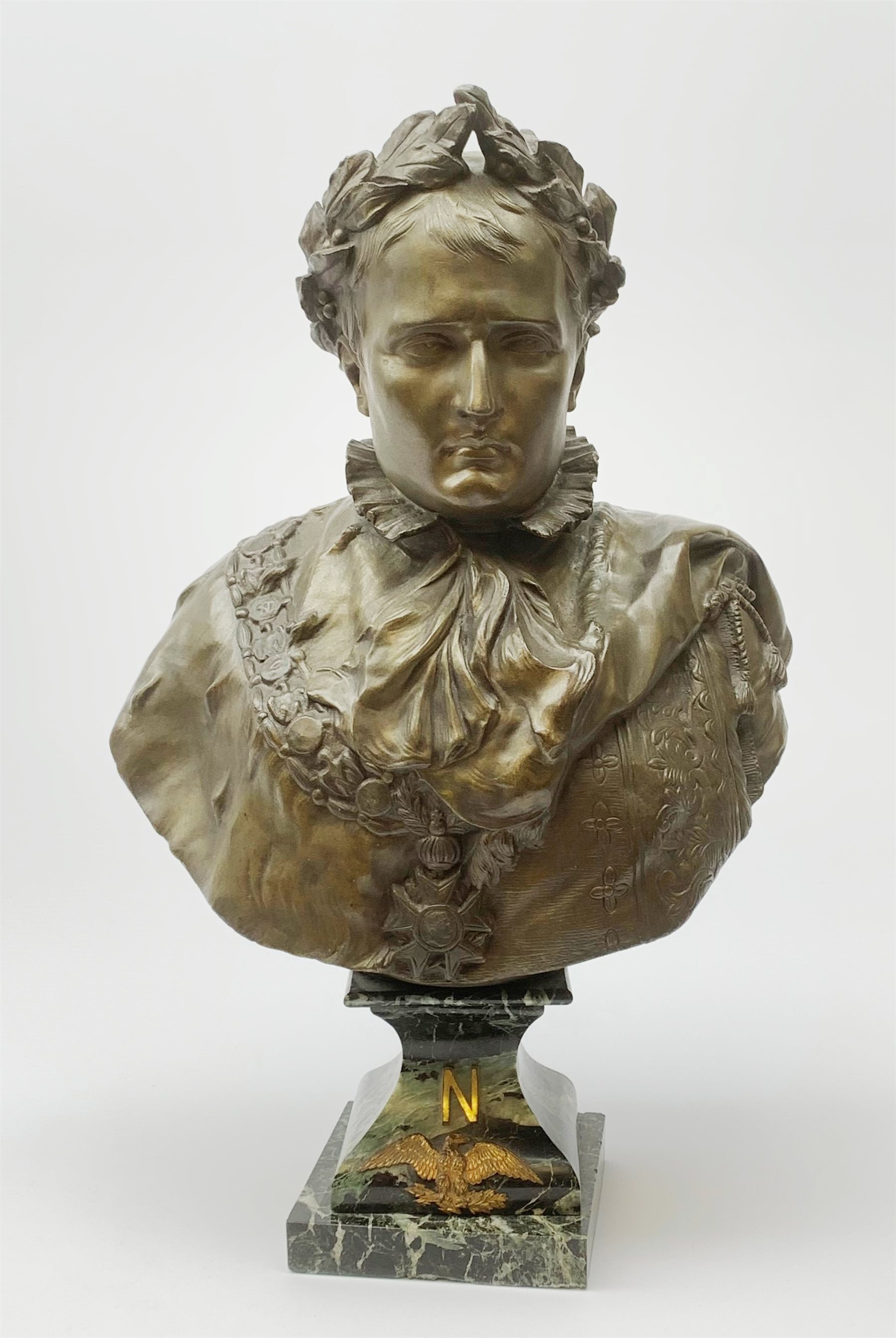 After R. Nannini, large bronzed spelter head and shoulder bust of Napoleon wearing a laurel wreath, on variegated green marble base with gilt metal 'N' and eagle, bears signature and Paris France fabrication medallion H54cm