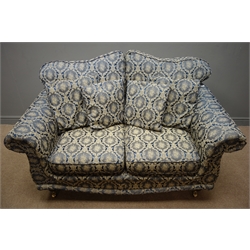  Two seat traditional style sofa floral pattern upholstery with mahogany feet on brass castors, W158cm  