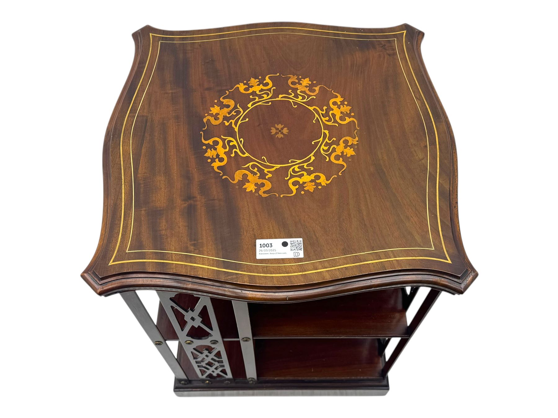Edwardian inlaid mahogany revolving bookcase, shaped square moulded top with central motif and satinwood band, two tiers with pierced vertical splats, on swivel action base with ceramic castors