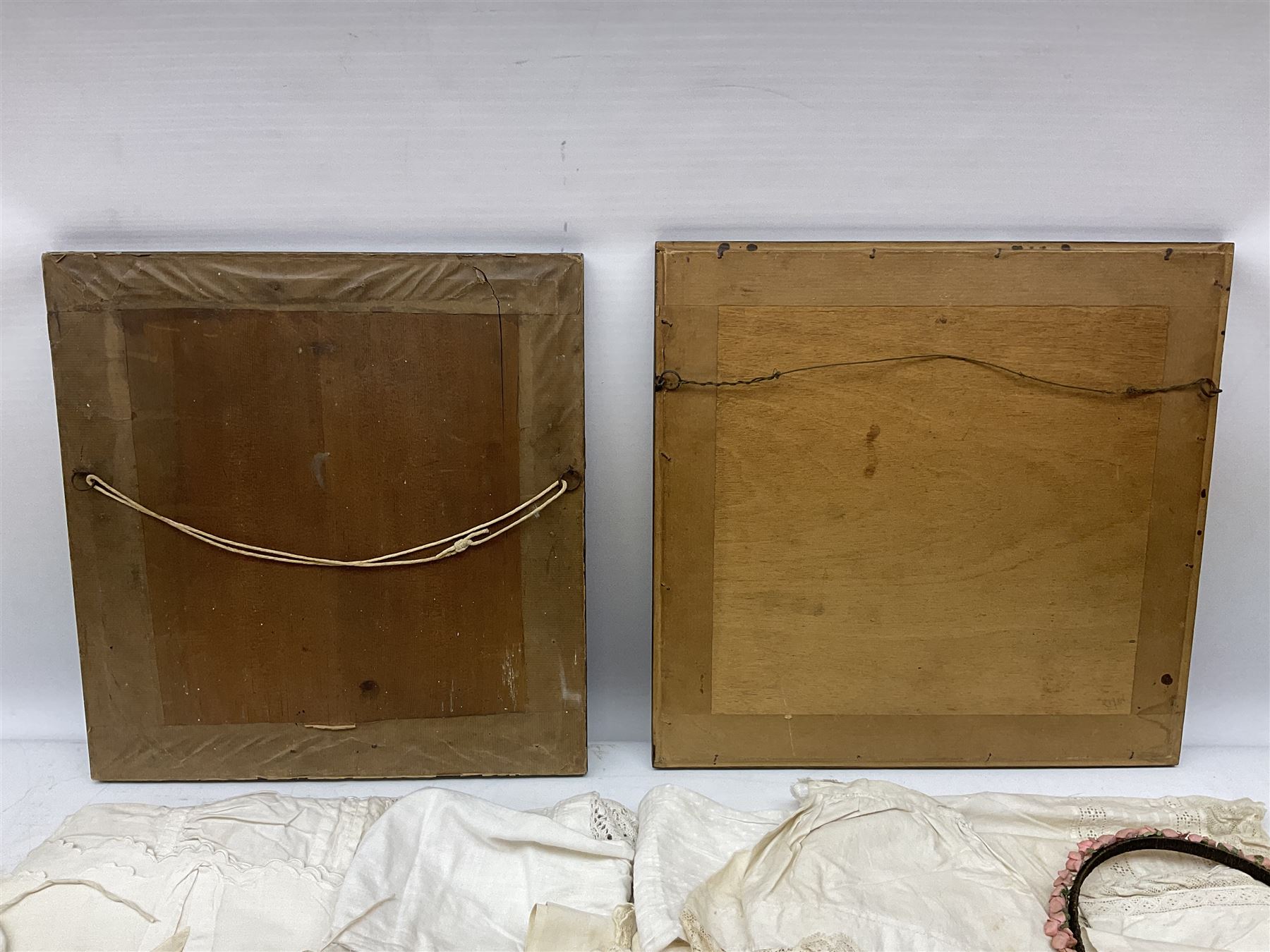 Late 18th century sampler worked with the alphabet above verses in red, by Mary Birkett aged 10 November 16th 1792, H33.5cm W34.5cm, together with another sampler worked with the alphabet above Proverbs 14:23, by Mary Anne Hainworth, Chesham, date unknown (--83), both in glazed frames, together with a quantity of Victorian and later dolls clothes to include lace examples