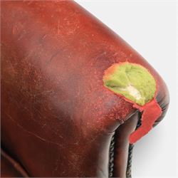 Georgian design wingback armchair upholstered in oxblood leather, the deep button upholstered back with shaped wings and out-scrolled arms, close nailhead trim to the edges, over a loose seat cushion, raised on cabriole front supports terminating in claw and ball feet