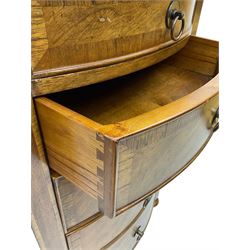 Frank Hudson - mid-20th century Mindi ash and burr walnut bow-fronted lingerie chest, crossbanded hinged top concealing vanity mirror, over five graduated cockbeaded drawers, raised on turned supports
