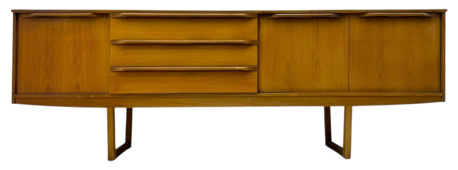 Mid-20th century teak sideboard, fitted with a fall-front cupboard, three drawers including a green baize-lined cutlery drawer, and a double cupboard, with integrated handles, on sleigh supports