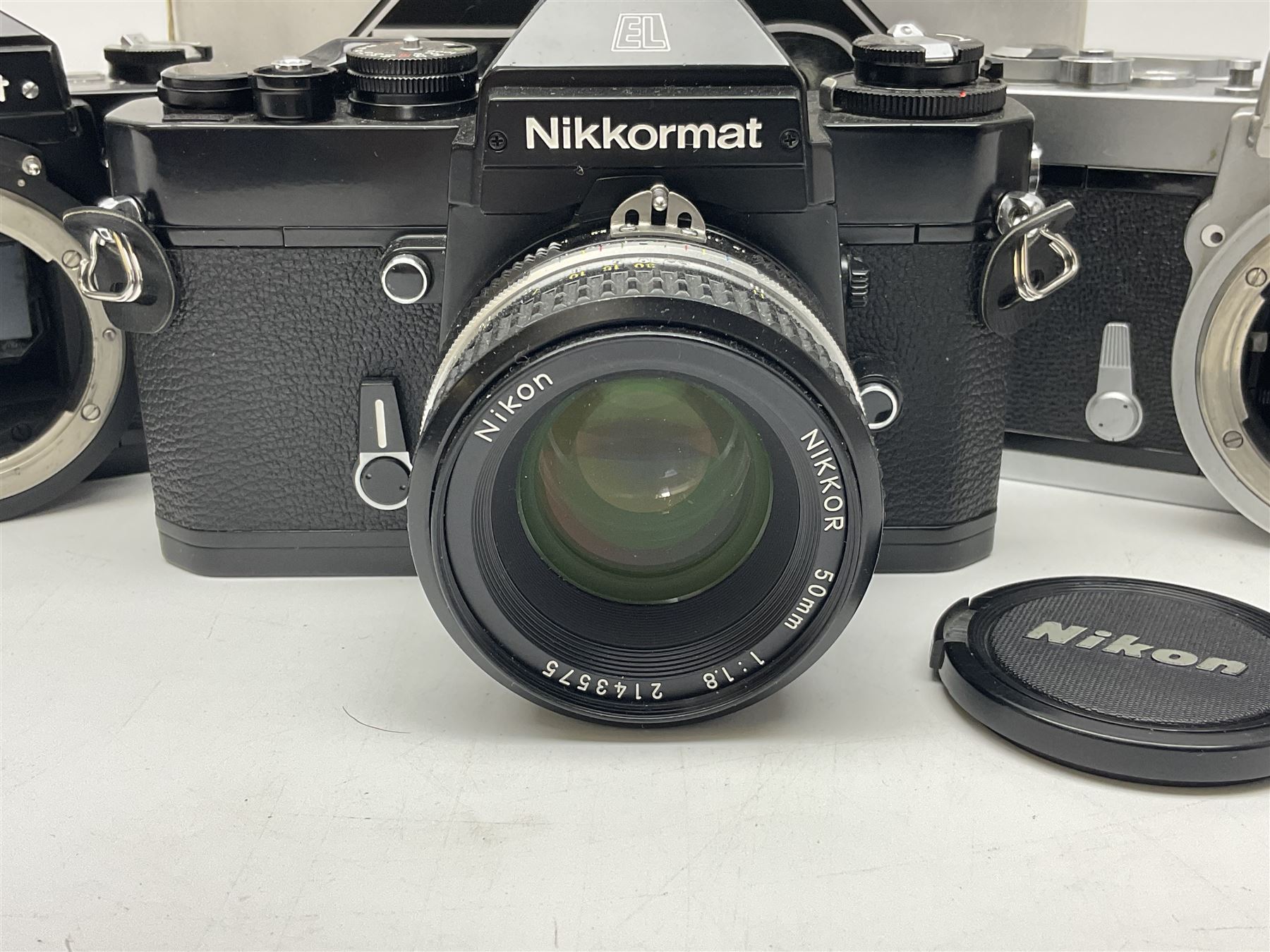 Nikkormat FT2 camera body, serial no. 5066813, in original packaging, together with Nikkormat EL camera body, serial no. 5577358, with Nikon Nikkor 50mm 1:1.8' lens no. 2143575, Nikkormat FT, serial no. 3968385, and Nikomat FT camera body, serial no. 4015491