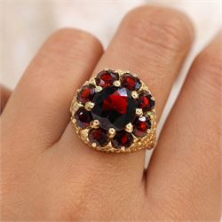 9ct gold garnet cluster ring, set with nine round cut garnets, with textured gallery and shoulders, hallmarked