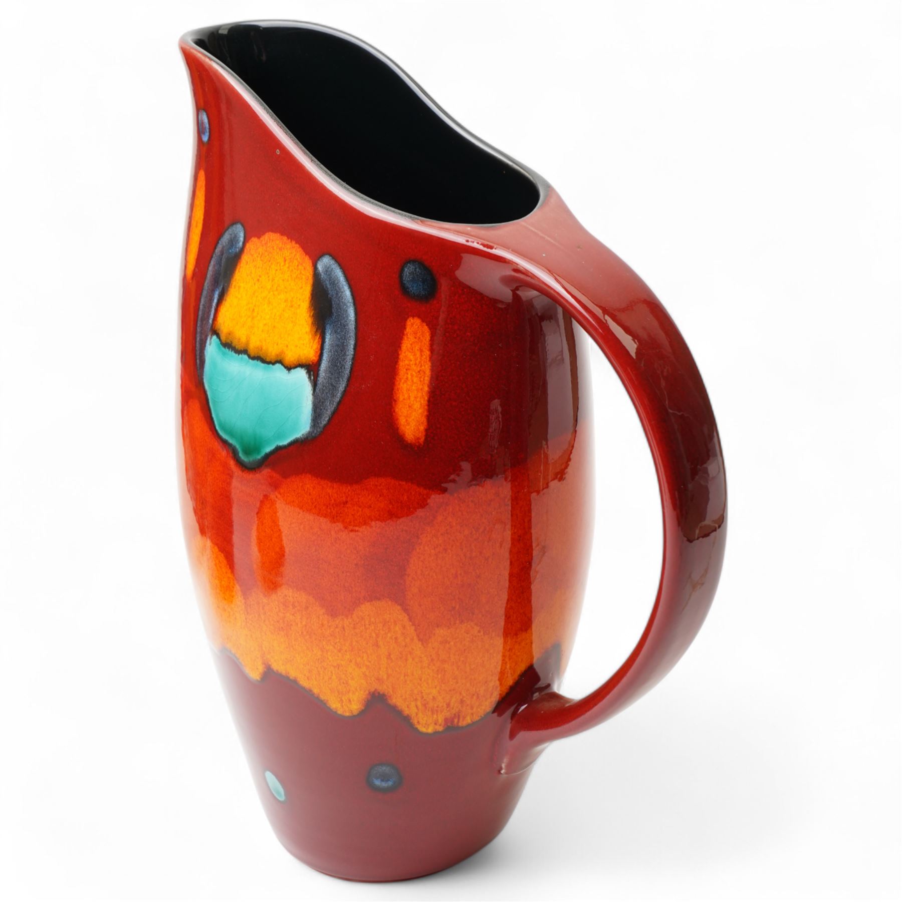 Four Poole pottery 'Volcano' pattern items comprising charger D40cm, pitcher H31cm, ginger jar and cover and salt pot (4)