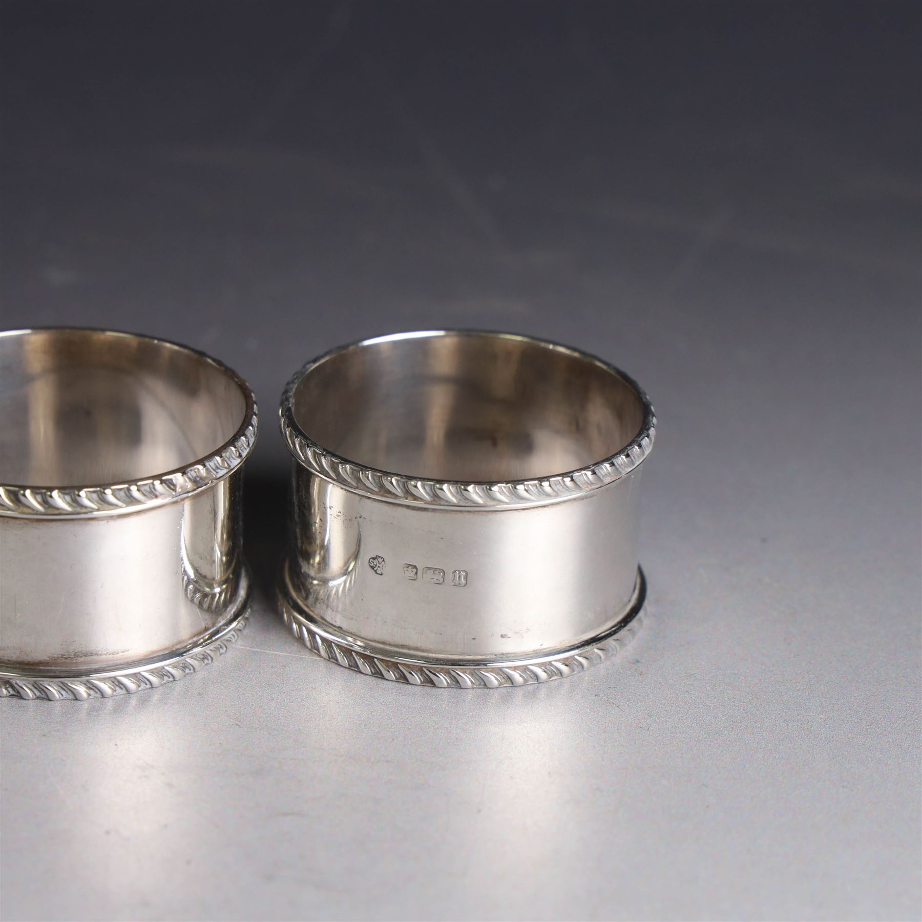 Pair of early 20th century silver napkin rings, plain circular form with oblique gadrooned rim, no engravings, hallmarked William Hutton & Sons Ltd, Sheffield 1912