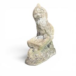 Two seated cast stone garden gnomes