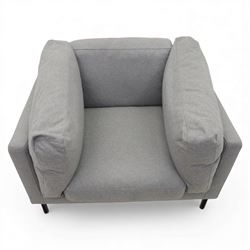 Modern snuggler armchair, upholstered in grey fabric, box-shaped frame with loose back and side cushions, raised on slender black metal legs