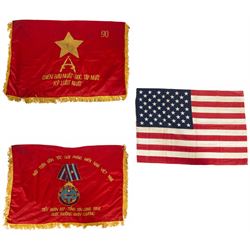 Vietnam War; two North Vietnamese military flags, together with a United States Marine Corps Vietnam period stars and stripes flag 