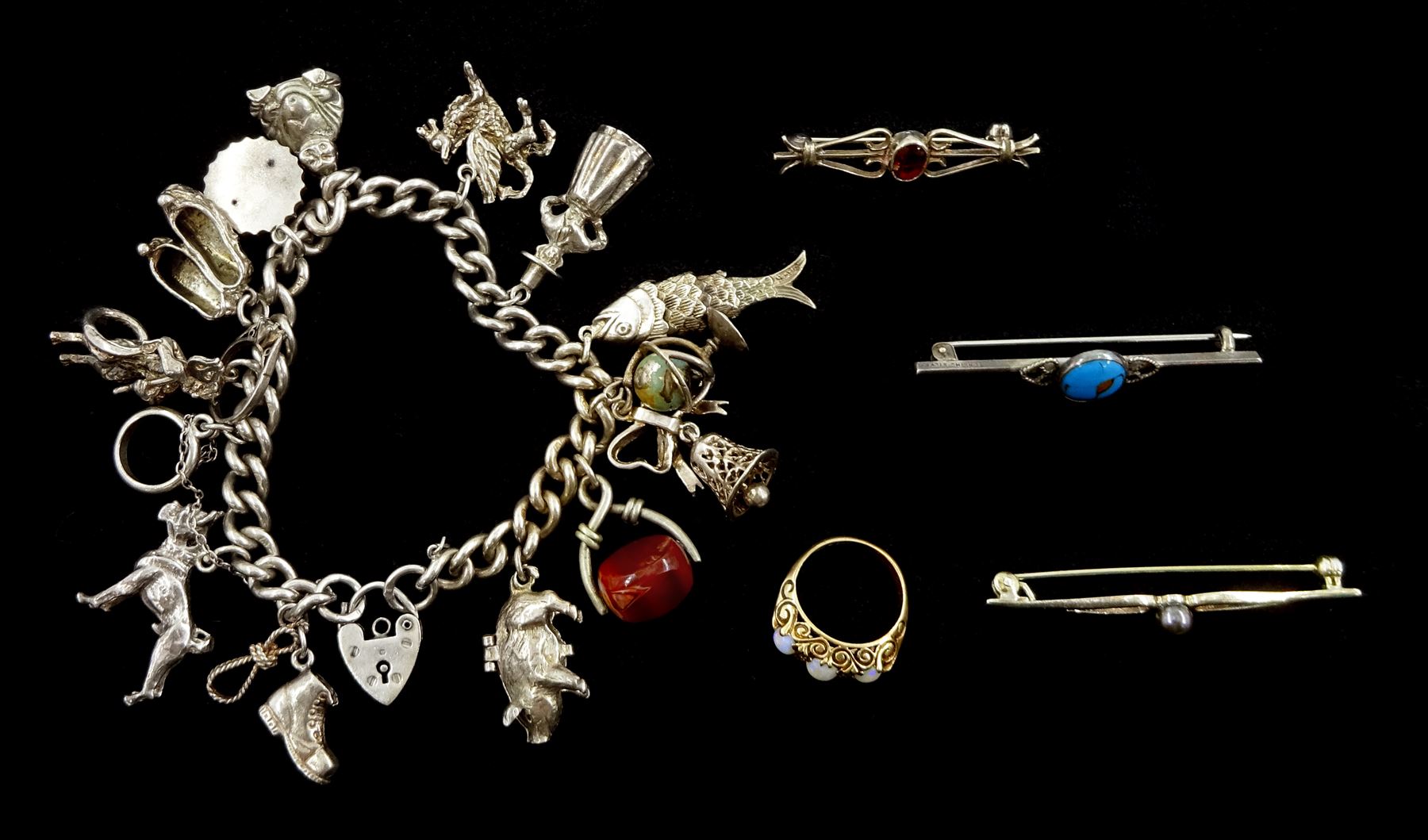 Silver charm bracelet including Welsh dragon, globe, British bull dog, pig, devil and fish, 9ct gold opal and cubic zirconia ring and three silver brooches