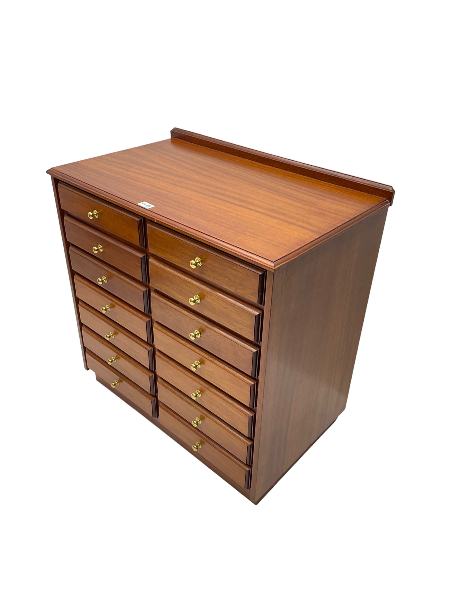 Late 20th century teak sheet music cabinet, fitted with fourteen drawers on plinth base 