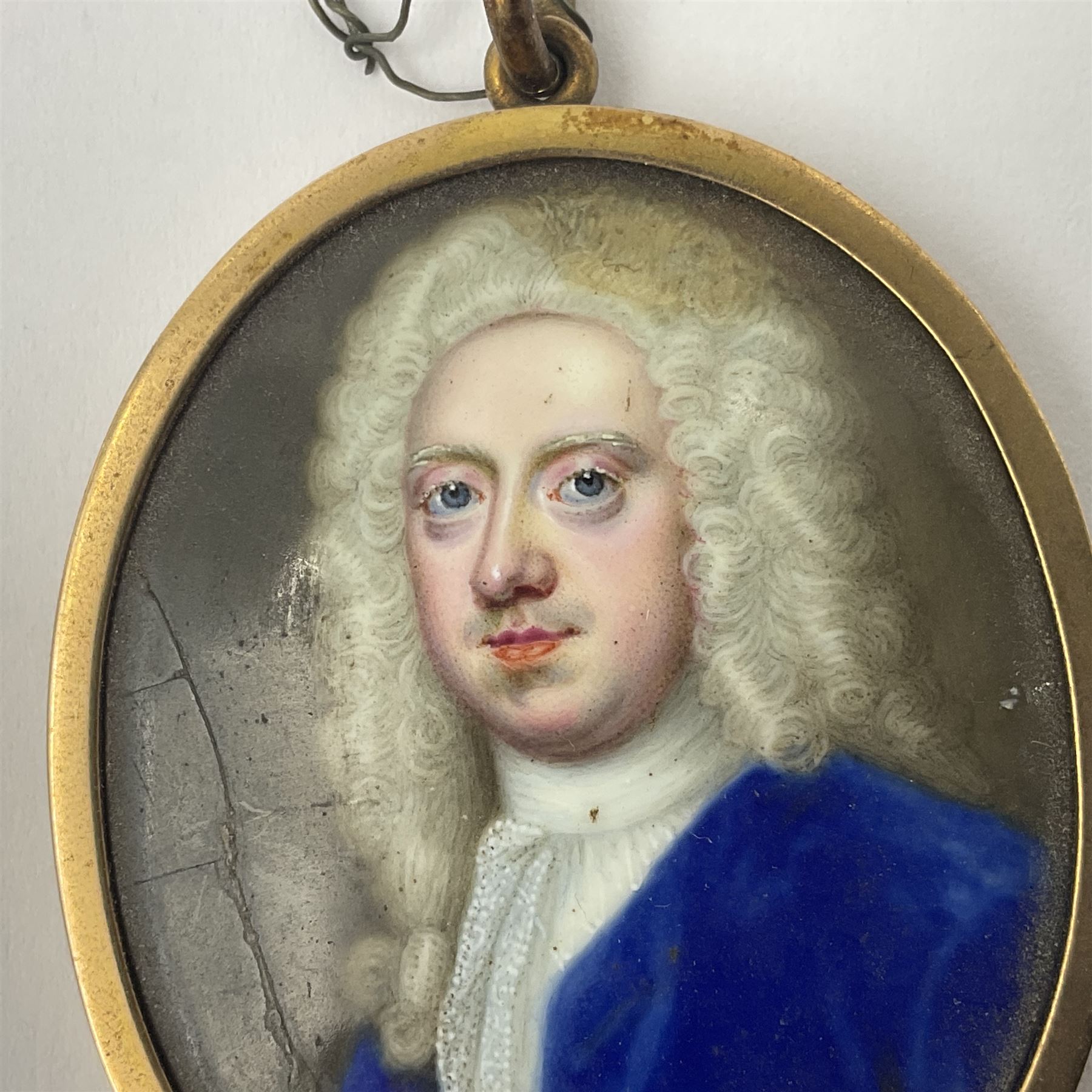 In the manner of Christian Zincke (German 1683-1767)
Portrait miniature upon enamel, circa 1750
Head and shoulder portrait of a gentleman in blue coat, possibly George II 
Within 9ct gold frame with ivory panel verso
Oval 4.5cm x 3.5cm

This item has been registered for sale under Section 10 of the APHA Ivory Act